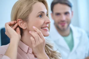 Woman with her hands touching ear