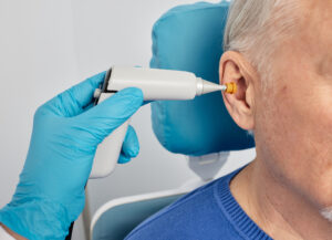 Search by image or video Portrait of mature man while tympanometry and test of middle-ear function with ENT-doctor using tympanometer probe at hearing center